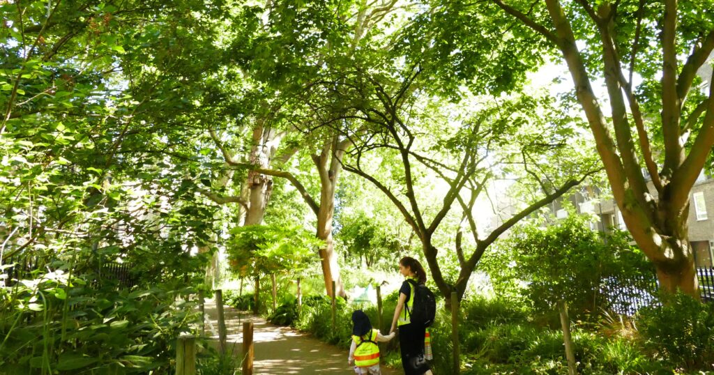 student walking with her teacher down a forest route