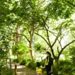 student walking with her teacher down a forest route