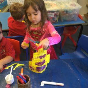 children creating a card cake