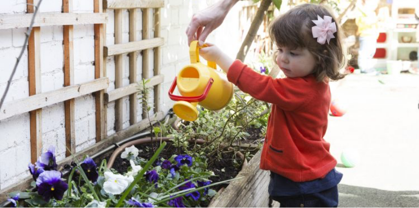 Child with a plastic watering can