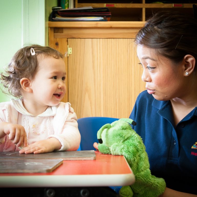 child playing with a plushie puppet