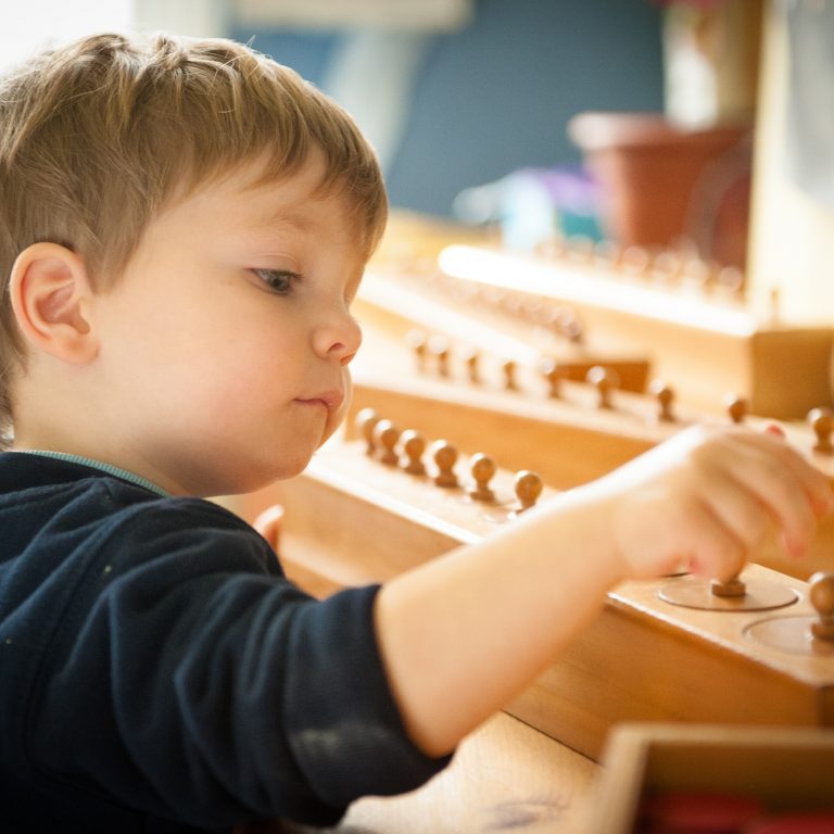 child using wooden counting toy