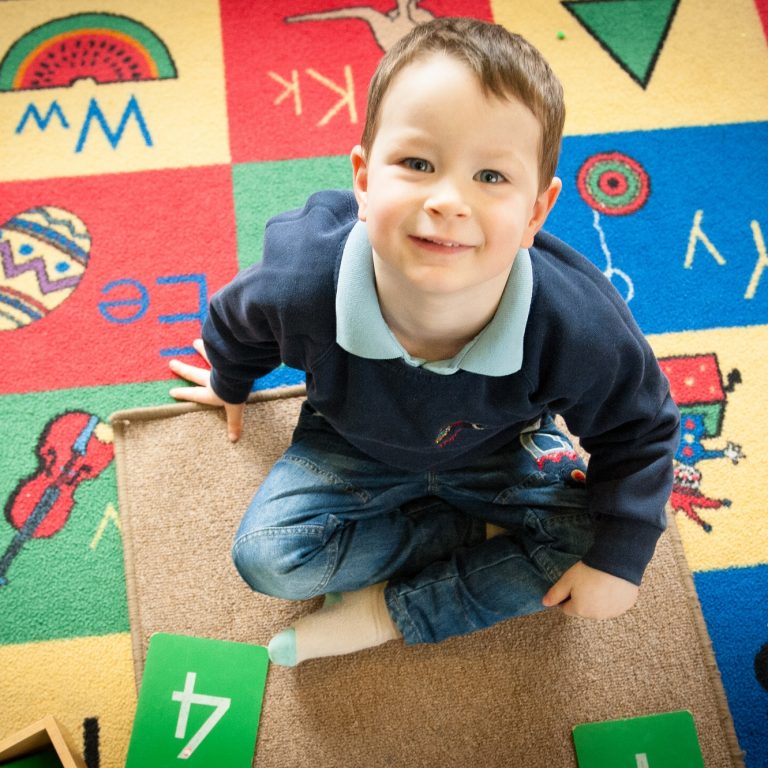 child sat on the carpet