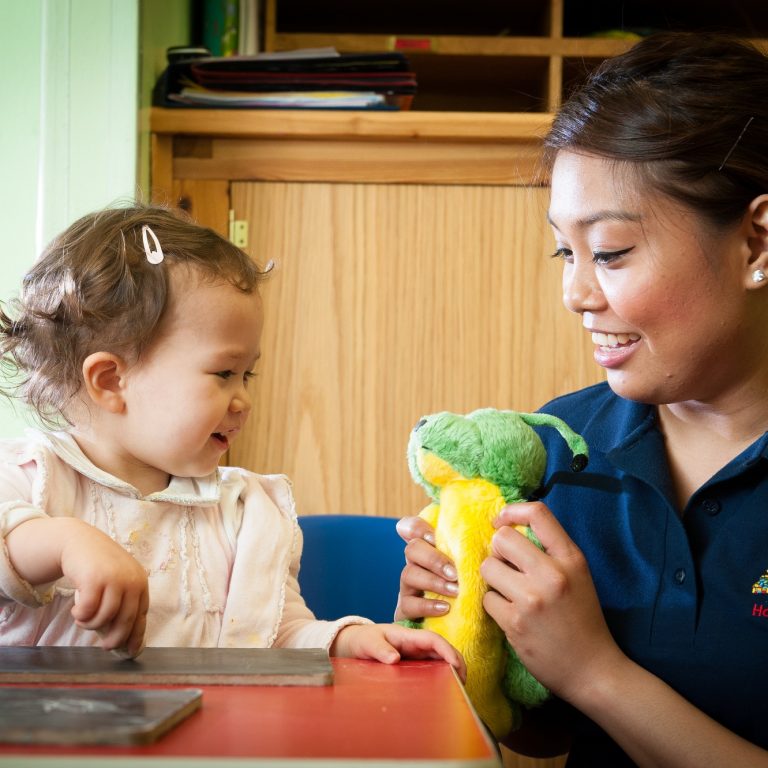 child looking at a plushie toy