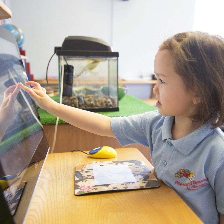 child using a touch screen desktop