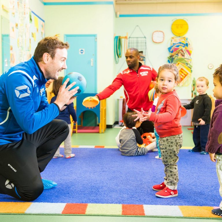 teachers playing ball with the children