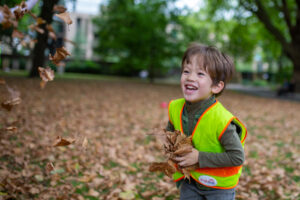 child holding leaves